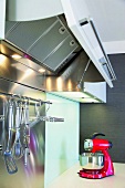 Eine rote Küchenmaschine in einer modernen Edelstahlküche