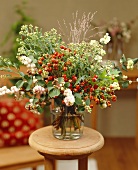 Arrangement of late summer flowers with wild berries