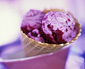 Raspberry ice cream in a cone