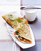 Pancakes with vegetable filling and herb cream sauce