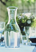 Carafe of water on laid garden table