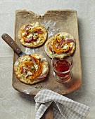 Tartes flambées topped with pumpkin, onions and feta
