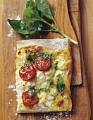 Tarte flambée with fresh goat's cheese, tomatoes and basil