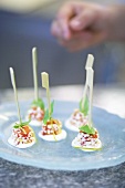 Melon on cocktail sticks on lime cream with grated white chocolate