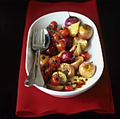 Roasted small apples, onions and tomatoes with herbs