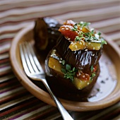 Aubergine and pepper tower with sesame seeds and herbs