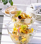 Two bowls of orange and fennel salad with olives and mint