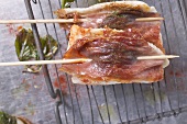 Two sole saltimboccas with ham on skewers