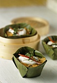 Peanut chicken in banana leaves cooked in bamboo steamer