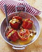 Four stuffed red peppers with bread and mushroom stuffing
