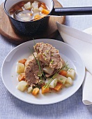 Boiled veal shank with carrot and celeriac broth