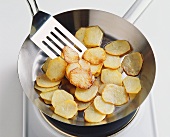 Frying potatoes in a frying pan