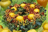 Christmas wreath of cotoneaster berries, holly, lemons