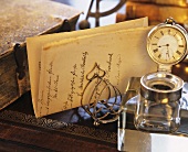Old desk with letter, inkwell, book