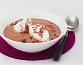 Chocolate soup with poached meringue