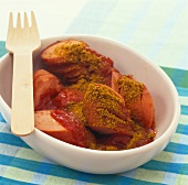 Currywurst (sausage with sauce and curry powder) in dish