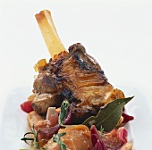 Lamb shank on apples and herbs