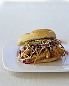 Grilled chicken and cabbage salad in a sandwich