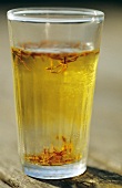 Saffron threads dissolving in a glass of water