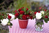 Different bunches of roses on a garden table