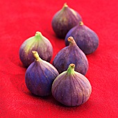 Fresh figs on red fabric