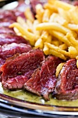 Beef steak with chips (close-up)