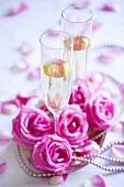 Two champagne glasses with roses and decoration