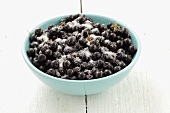 A bowl of chokeberries with sugar
