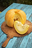 A sliced pumpkin on a blue garden table