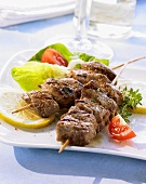 Grilled lamb kebabs with a salad garnish