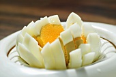 A sliced egg in an egg cutter (close-up)