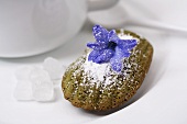 A madeleine with green tea and a hyacinth flower