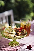 Various sandwiches on a table in a garden
