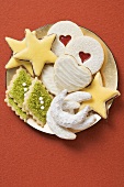 Various Christmas biscuits on a golden plate