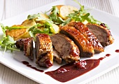 Duck breast with berry sauce and roast potatoes