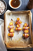Pumpkin kebabs wrapped in bacon with orange sauce and rice