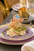 Prawns baked in spring roll dough on a potato and cucumber salad
