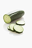A cucumber, partially sliced