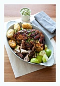 Roast pork with herbs, limes and potatoes