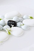 White stones and grey stone with the word 'Glück' (Luck) written on it