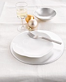 A place-setting with Christmas baubles