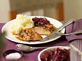 Glazed chicken breast with mashed potato and red onions