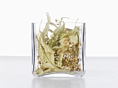 Dried lime flowers in a glass container