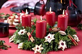 Advent wreath with red candles and biscuits