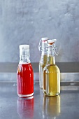 Strawberry juice and elderflower syrup in flip-top bottles