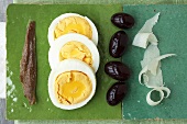 Anchovy fillet, boiled egg, olives and Parmesan shavings