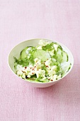 A small bowl of cucumber salad with dill and feta cheese