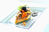 Fried sea bass with squid ink pasta