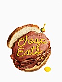 Pastrami sandwich with Cheap Eats written in mustard