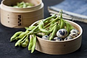 Soya beans and quails' eggs in a bamboo steamer